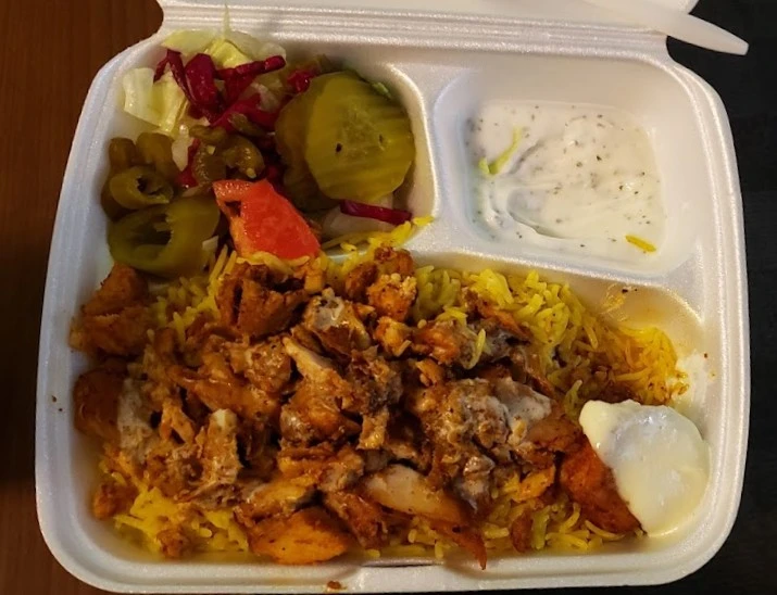 Chicken shawarma platter with pickles, hot peppers and garlic sauce at King of Shawarma Calgary