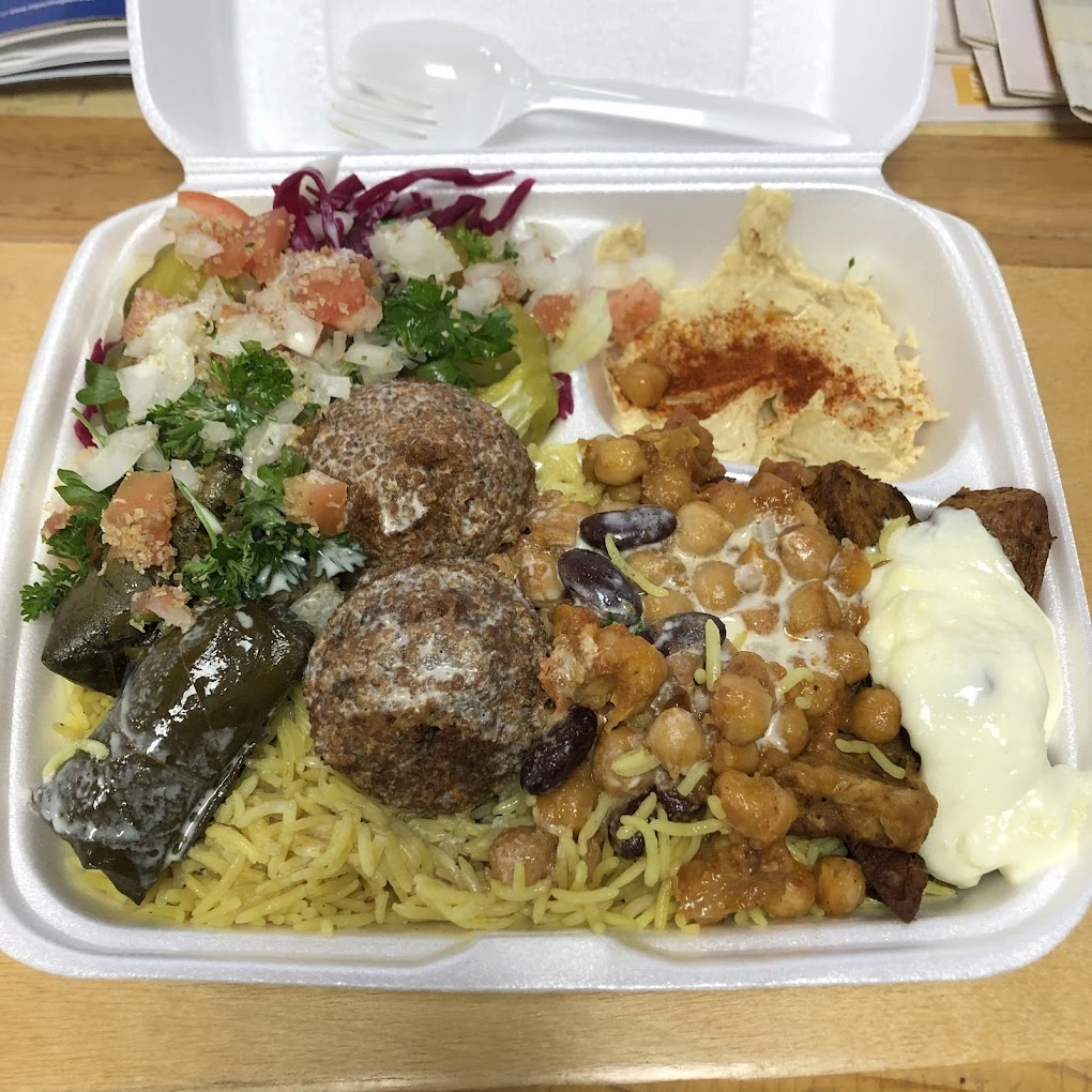 Falafel platter with grape leaves, chickpeas, hummus and seasoned rice at King of Shawarma Calgary