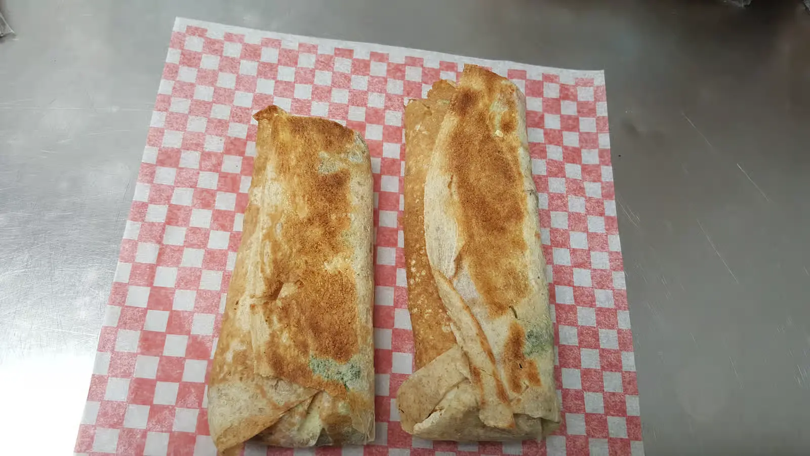 Two grilled shawarma wraps fresh off the press at King of Shawarma Calgary
