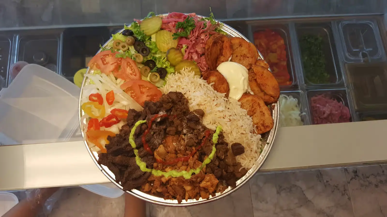 Shawarma family platter with beef and chicken, rice, garlic potatoes and salad at King of Shawarma Calgary